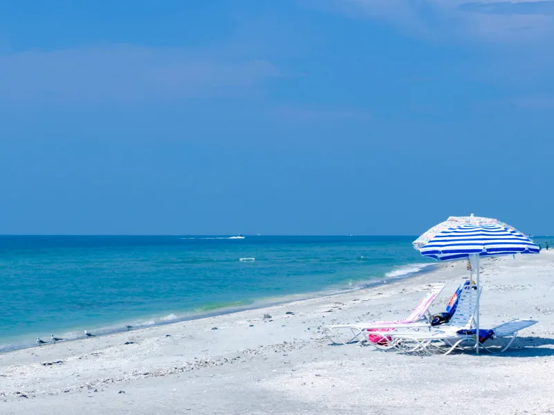 Sanibel Island Beach with sun chairs and umbrella 