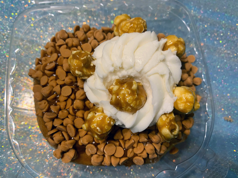 donut with butterscotch chips, frosting, and caramel popcorn 